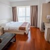 Отель Qingdao Dusco Holiday Apartment, фото 13