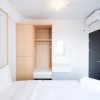 Отель Comfy And Spacey 2Br Apartment At Suncity Residence в Сидоарджо