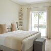 Отель LovelyStay - 2BR Modern, Pool Access, Close to Marina & Beach в Картейре