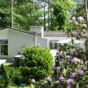Отель Detached villa with enclosed wooded garden with lawn, jacuzzi and infrared sauna в Холтене