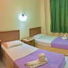 Отель OYO HOME 90700 Teluk Batik Holiday Apartment, фото 6