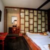 Отель Lijiang Xunniuge Guest House, фото 9