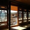 Отель Bai Sha Travellers Inn в Лицзяне
