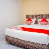 Отель OYO 433 Nelvi Guest House Syariah, фото 5