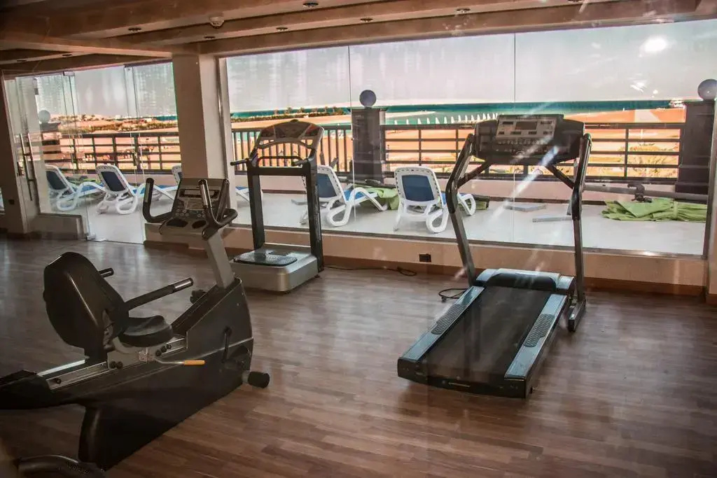 صورة: Gravity Hotel & Aqua Park Hurghada  Families and Couples Only: A bright fitness room with cardio equipment and views of loungers outside.