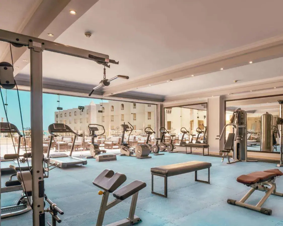 AMC Royal Hotel & Spa: An indoor fitness center with cardio machines and strength-training equipment.