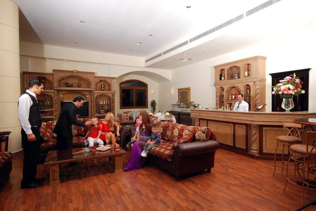Nubian Island, Families and Couples only: A warmly furnished lounge with comfortable sofa seating and a staffed bar.