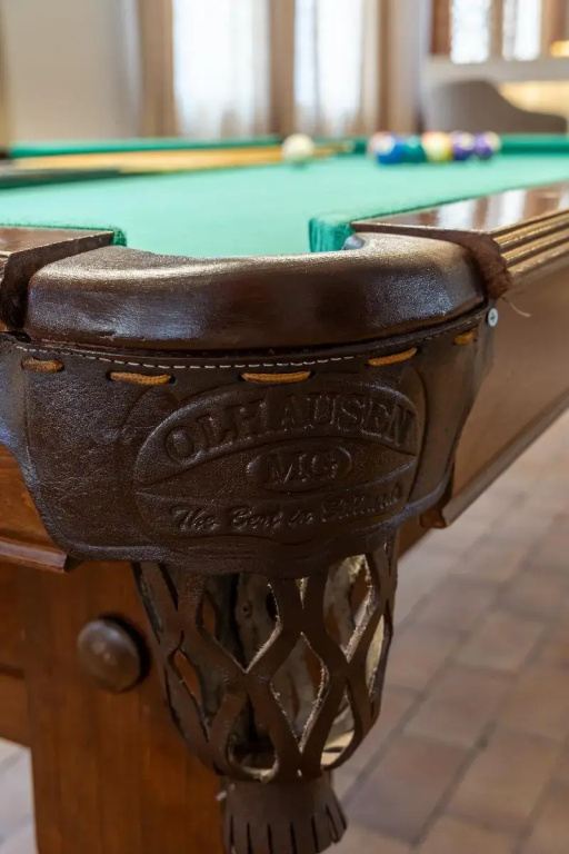 Fort Arabesque Resort, Spa & Villas: A classic billiards table with green felt and colorful pool balls sits in a bright indoor recreation area.