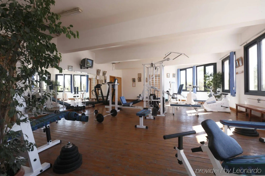 Pharaoh Azur Resort: A bright gym with strength-training machines, benches, and weights.