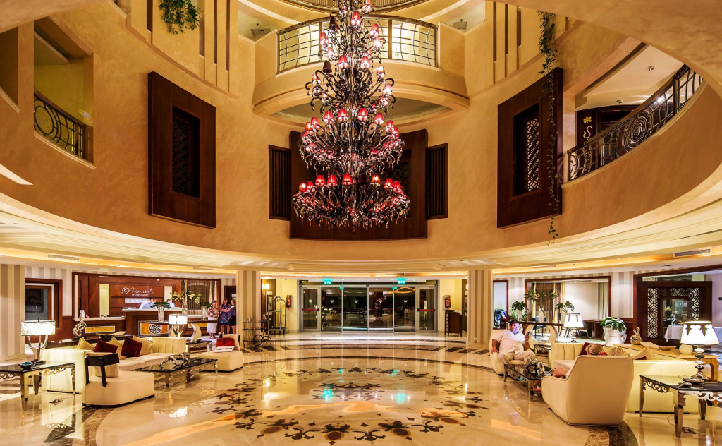 KaiSol Romance Resort Sahl Hasheesh (Adults Only): Grand hotel lobby with a reception desk, comfortable lounge seating, and an ornate chandelier.