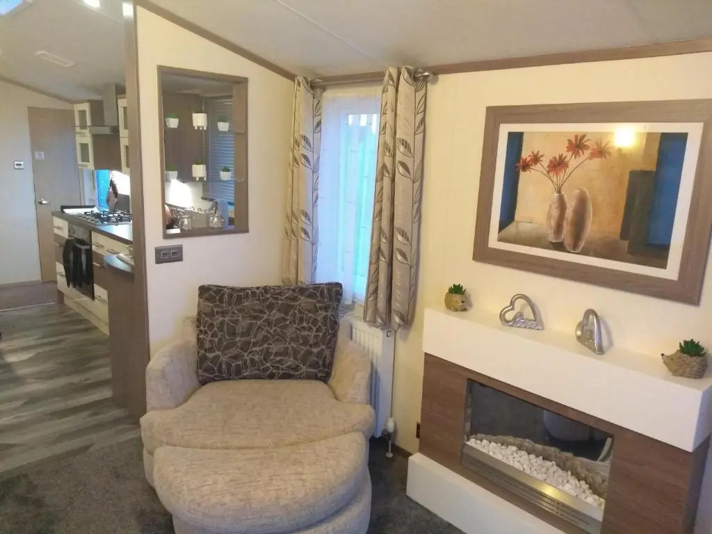 E3 is a 2 Bedroom 6 berth Lodge on Whitehouse Leisure Park in Towyn near Rhyl with Free WiFi, decking and private parking space