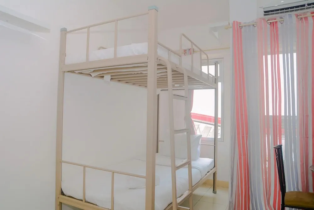 Green Bay Pluit Studio Apartment with 2 Single Beds by Travelio