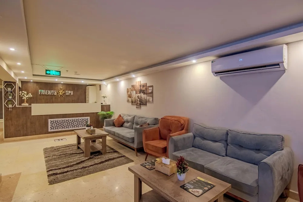 Rewaya Inn Resort: A welcoming lounge with generous sectional seating, coffee tables, and a visible spa sign.