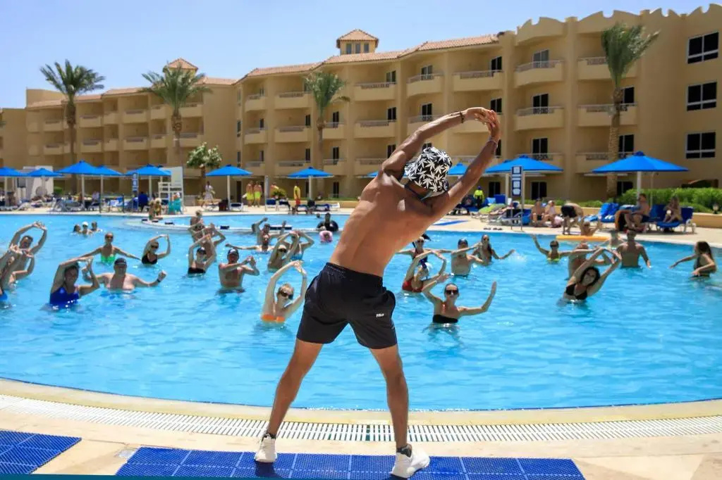Amwaj Beach Club Abu Soma: Guests join a group pool workout in the resort’s outdoor swimming pool.