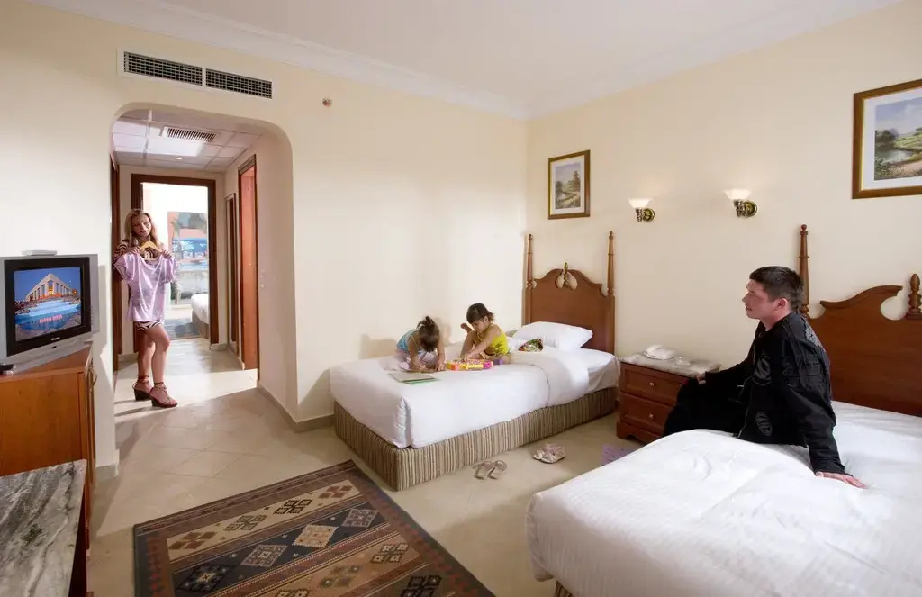 Titanic Beach - Families and Couples only: A family-friendly bedroom with two beds, a television, and space to relax together.