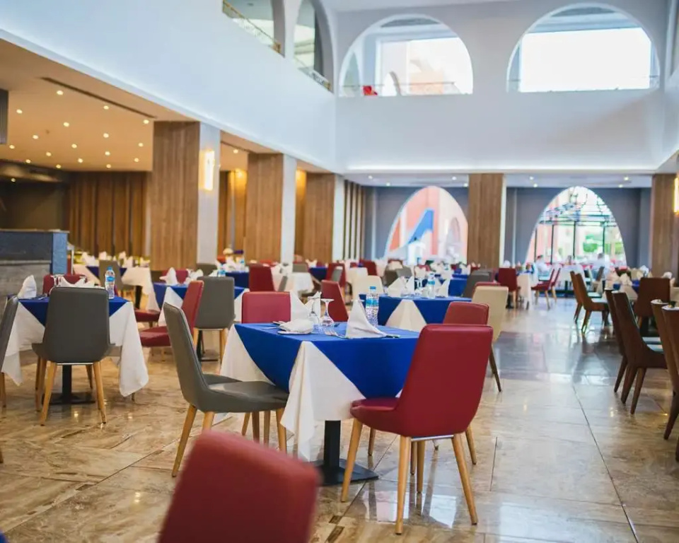 Titanic Palace - Families and Couples only: Spacious restaurant dining room with neatly set tables and colorful chairs.