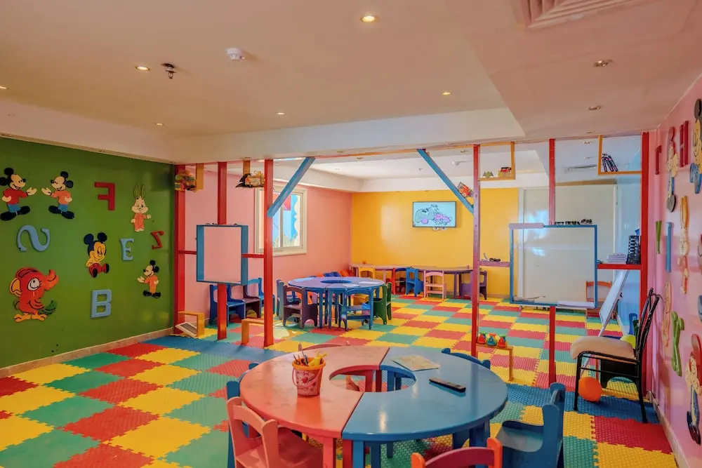Rewaya Inn Resort: A bright children's playroom with colorful floor mats, child-sized tables and chairs, and activity boards.