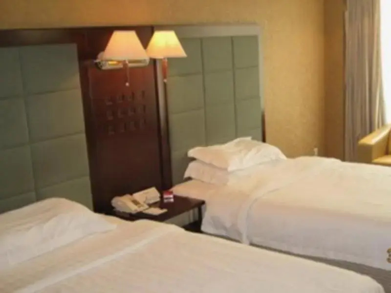 Huaweida Hotel - Chambres