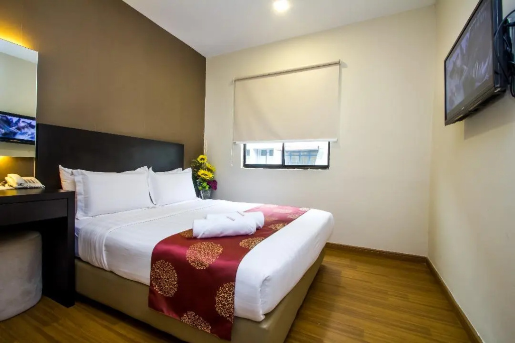 Capital O 91074 Grand World Hotel - Chambres