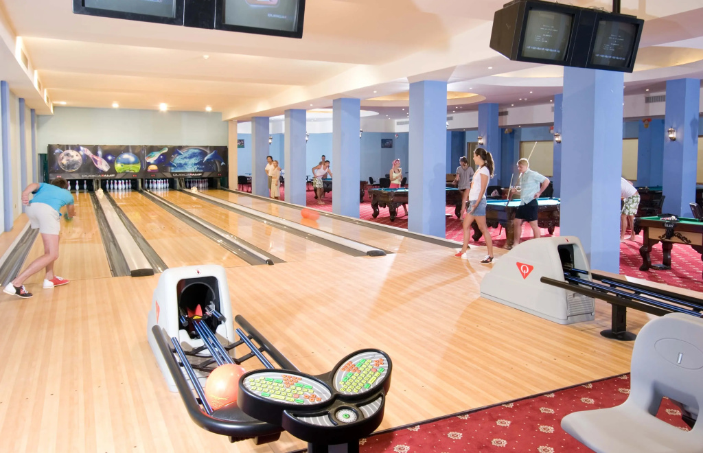 Titanic Palace - Families and Couples only: A bright indoor recreation area with multiple bowling lanes and billiards tables.