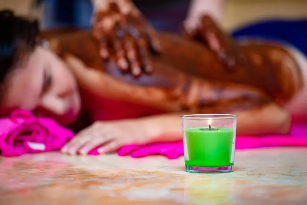 Prima Life Makadi Hotel - All inclusive: A bright green drink sits on a table, with hands visible in the background.
