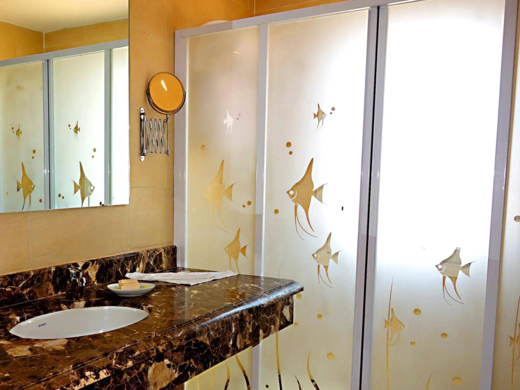 Viva Blue Resort and Diving Sharm El Naga (Adults Only): A bright bathroom with a long dark stone vanity, white basin, and large mirror panels.