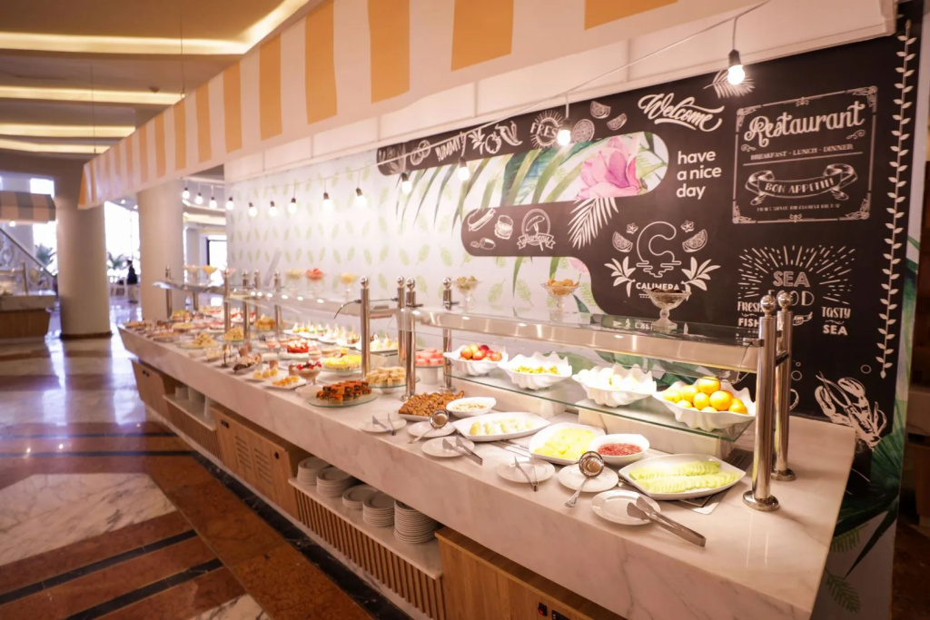 Calimera Blend Paradise: A restaurant buffet offers a spread of prepared dishes, fresh fruit, and desserts.