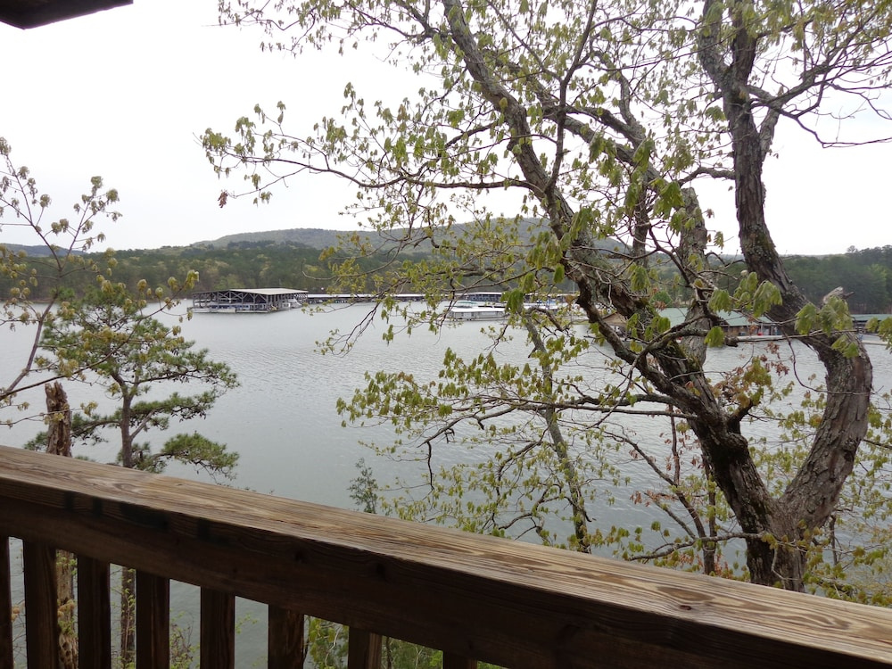 Lake view three bedroom, three bath log-sided cottage with private hot tub overlooking Lake Ouachita. by RedAwning