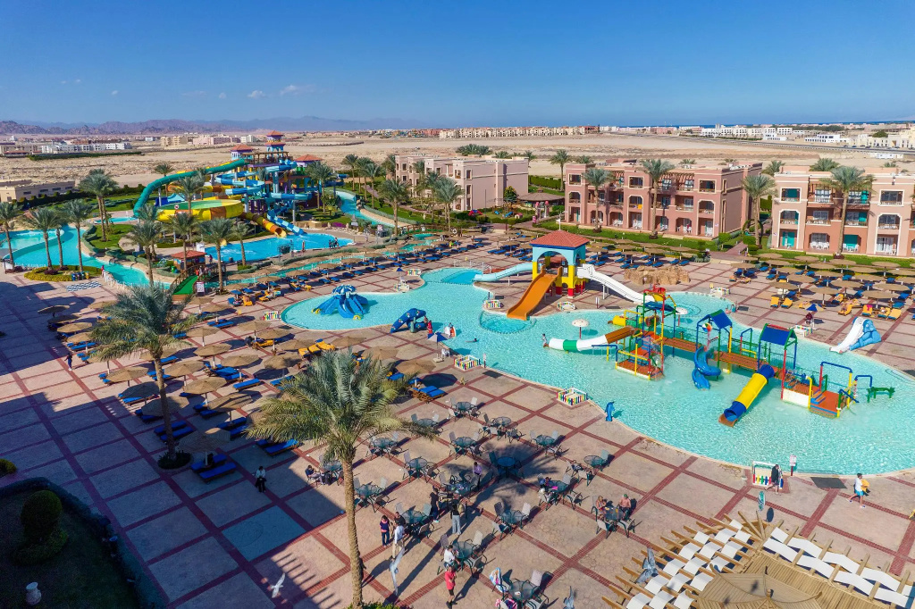 Charmillion Club Aqua Park: An expansive outdoor water park features multiple pools, colorful water slides, and poolside loungers.