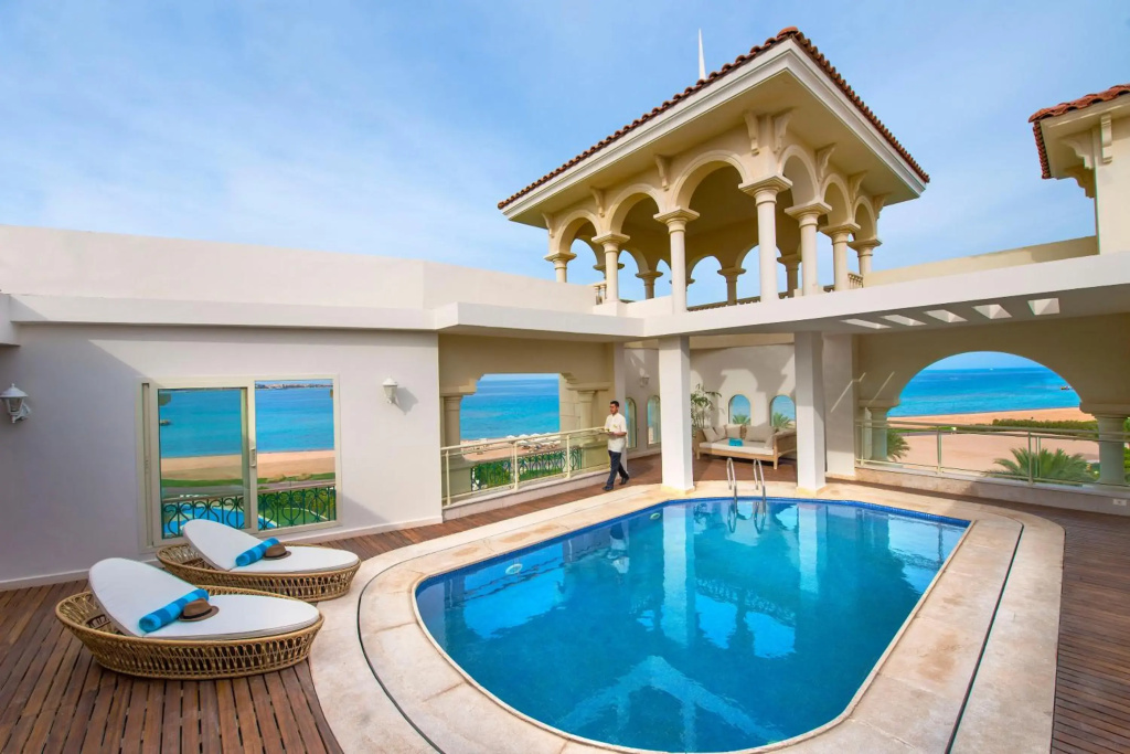 Baron Palace Sahl Hasheesh Resort: A sunlit terrace with a private pool, loungers, and sweeping sea views.