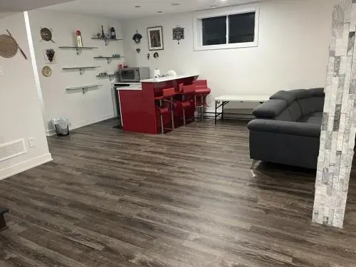 Private room and bathroom with living area in a basement