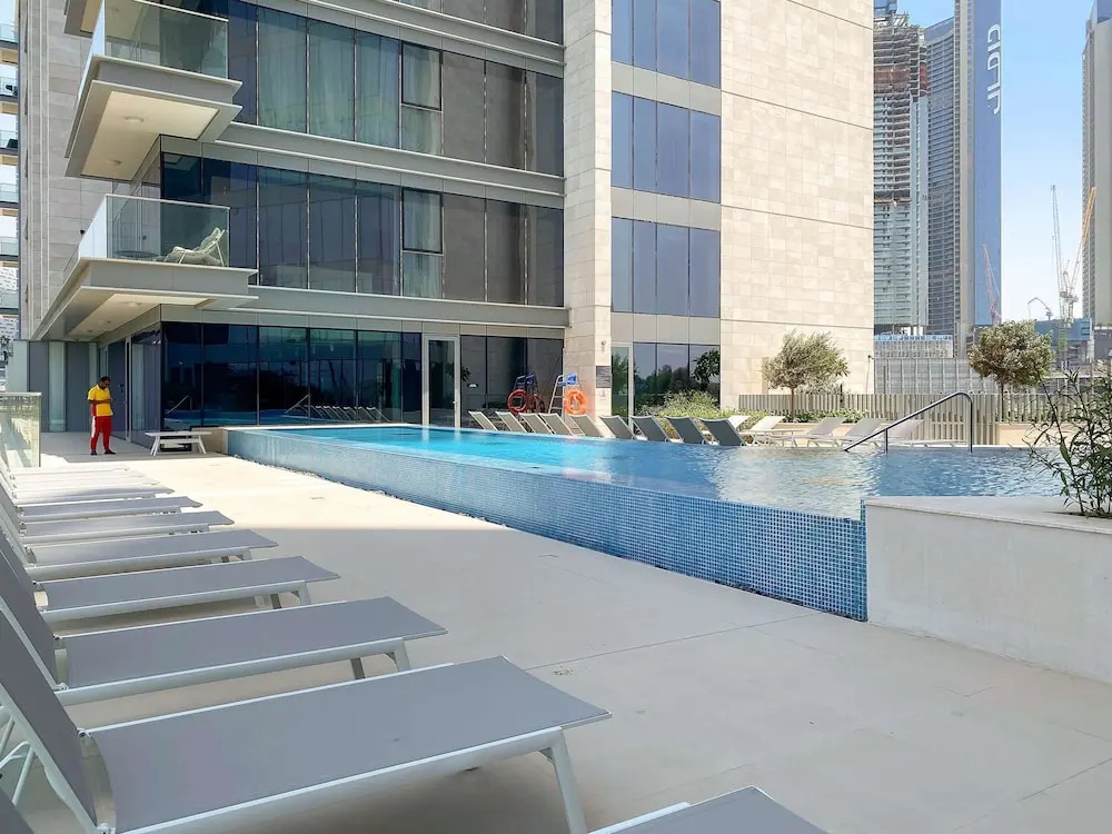Bright 1BR Escape w Balcony Building Pool