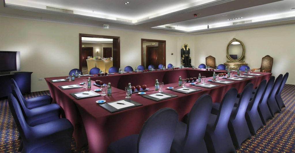 Palm Royale Resort - Soma Bay: A meeting room set in a U-shaped layout, with conference seating, notepads, and refreshments.