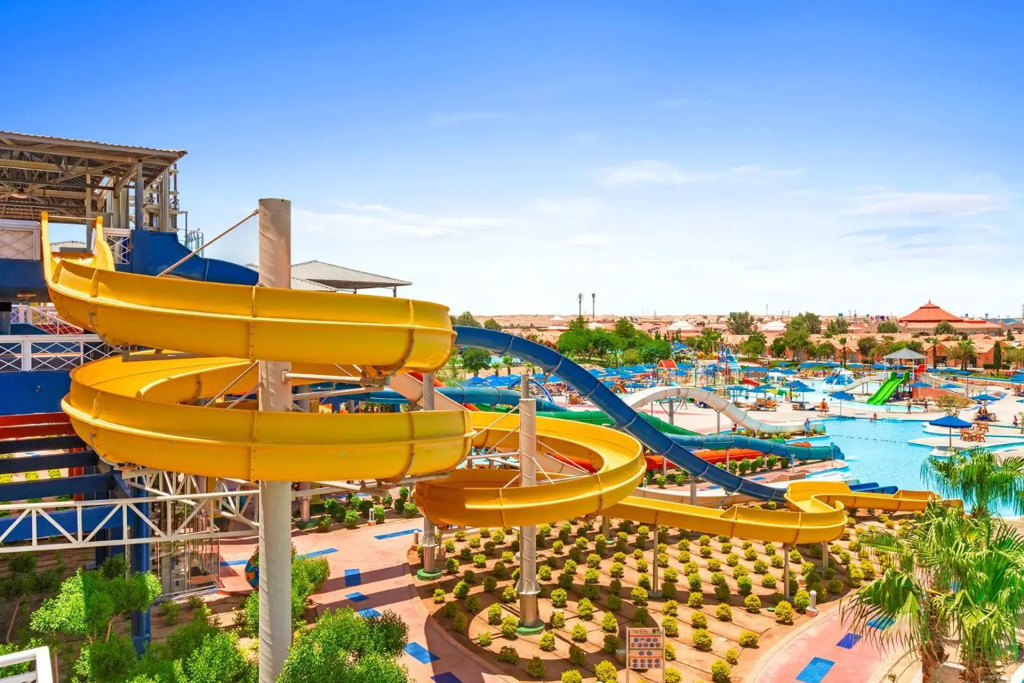 Pickalbatros Jungle Aqua Park - Neverland Hurghada: A lively outdoor water park with colorful twisting slides, swimming pools, and poolside loungers.