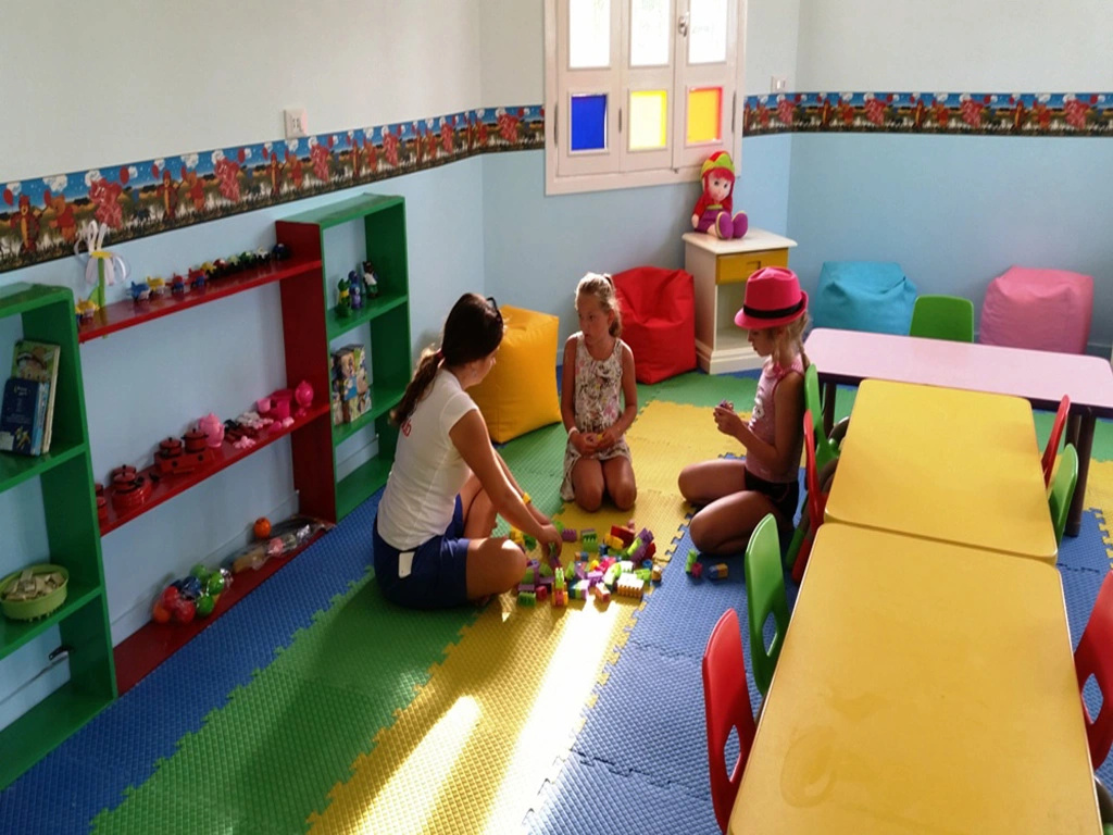 Albatros Makadi Resort: A colorful indoor play area with toys, soft floor mats, and child-sized tables and chairs.