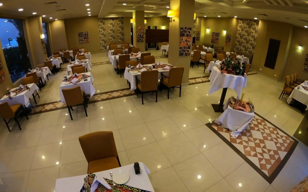 Romance Regency Club Adult Only (+16) - Ultra All Inclusive: An inviting indoor restaurant dining room with white-clothed tables and warm lighting.