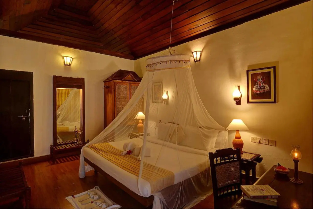 Somatheeram Ayurveda Village in Kerala, traditional cottages among palms above the beach