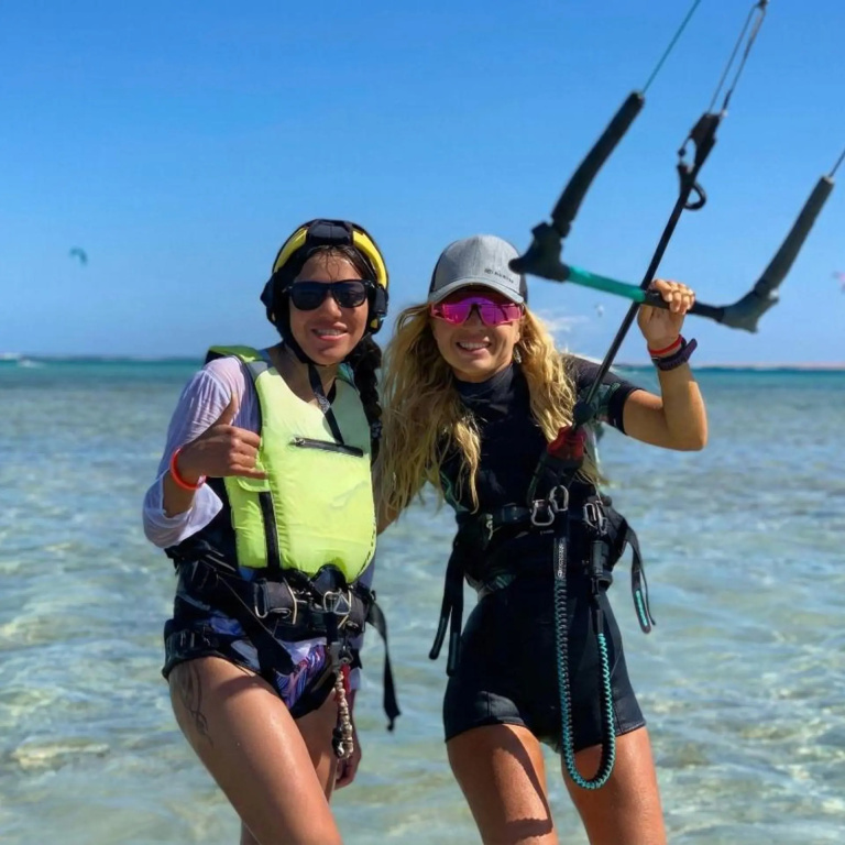 Romance Regency Club Adult Only (+16) - Ultra All Inclusive: Two people pose in clear shallow water with kiteboarding gear.