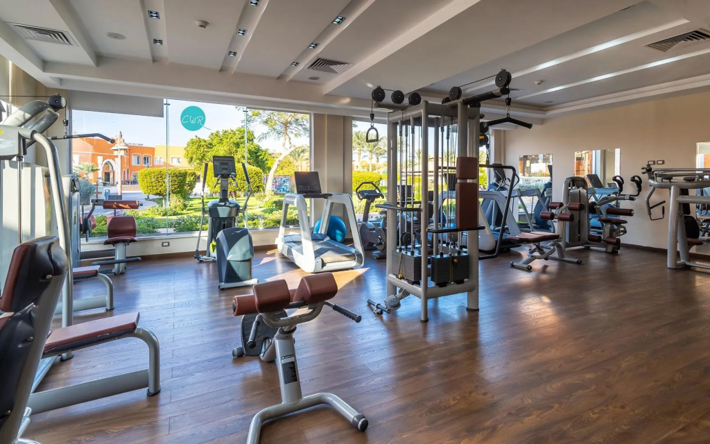Sentido Caribbean world soma Bay: A bright fitness center with cardio machines and strength-training equipment.