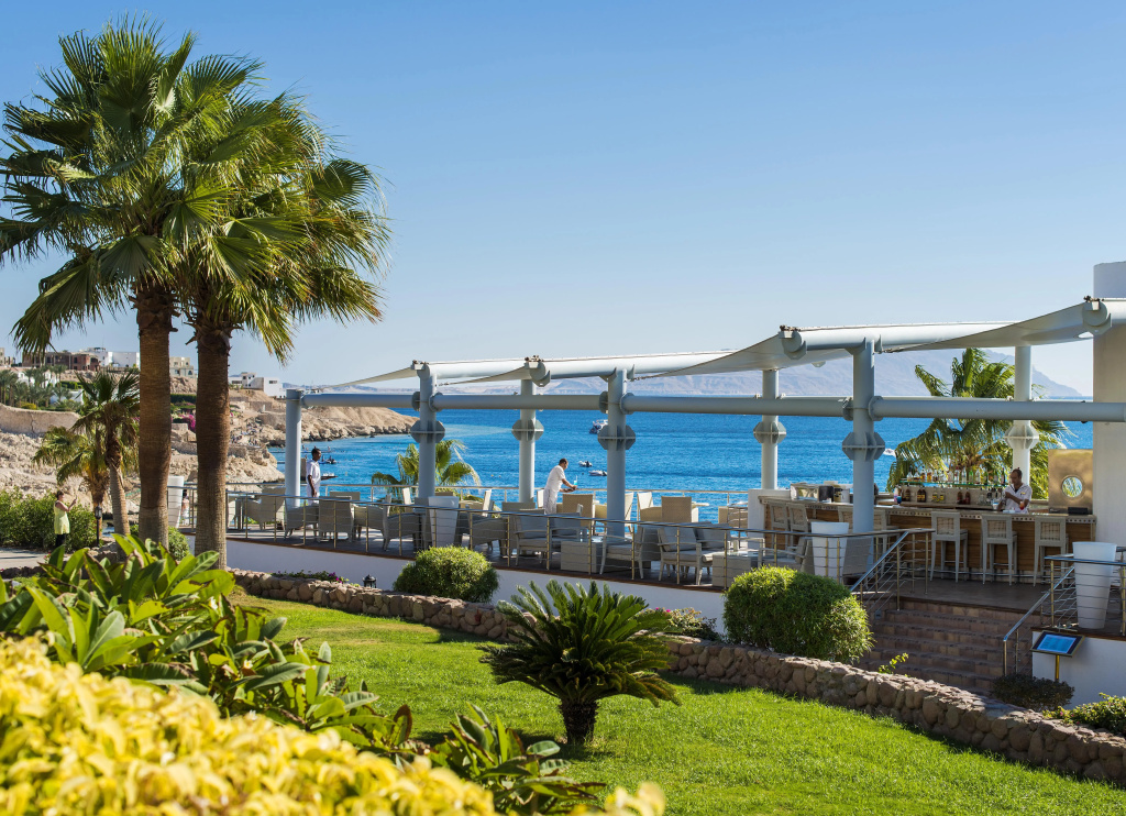Concorde El Salam Sharm El Sheikh: An open-air terrace with bar seating, landscaped gardens, and views across the sea.