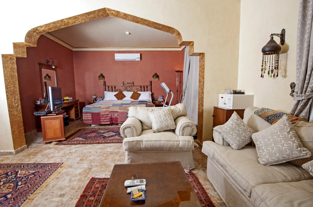 SUNRISE Garden Beach Resort: A spacious suite-style room with a separate bedroom alcove, a comfortable lounge area, and air conditioning.