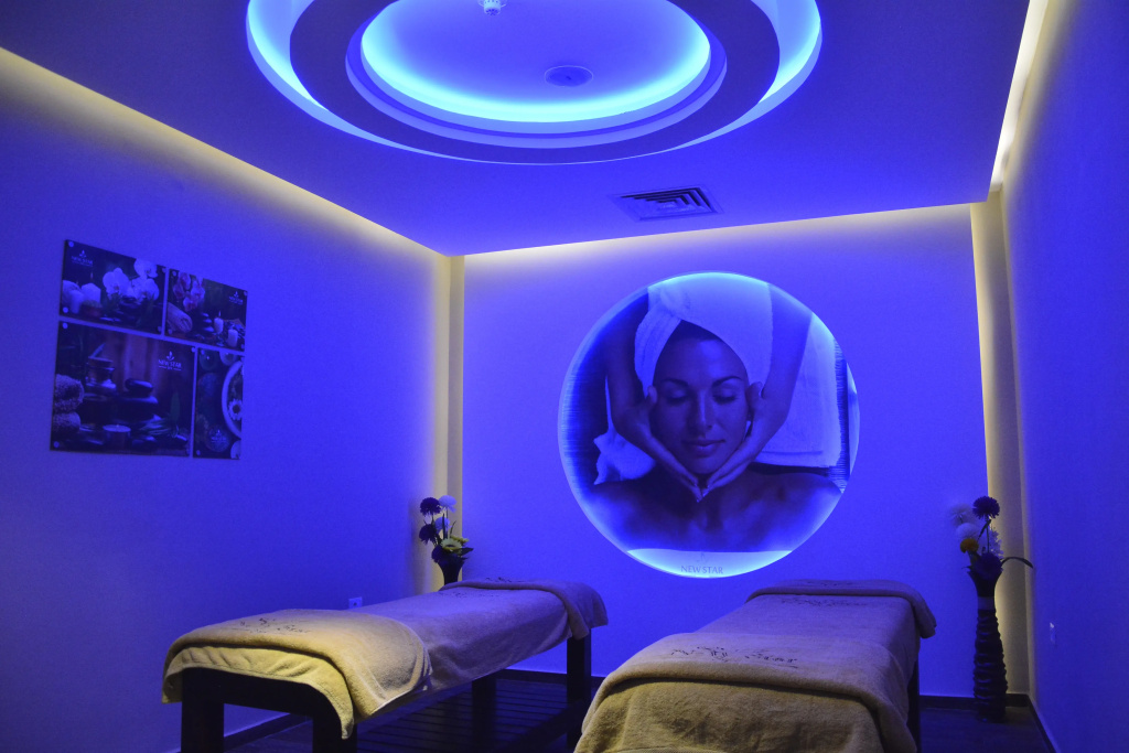 Concorde El Salam Sharm El Sheikh: A softly lit spa treatment room with two massage tables and blue accent lighting.