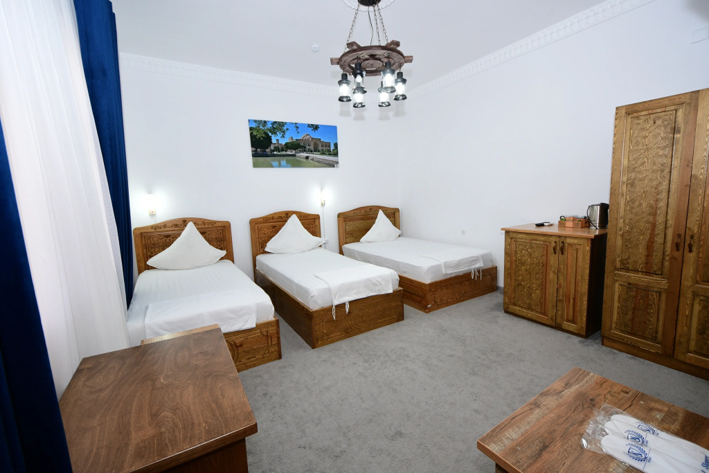 Deluxe Triple Family room with courtyard view