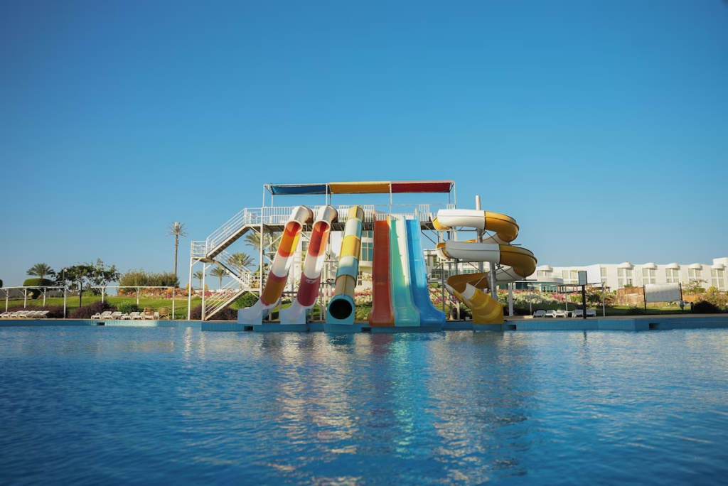 Sun Resort Aqua Park Sharm El-Sheikh: A large outdoor pool with colorful water slides sits in front of the resort buildings.