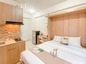Warm and Well Designed Studio Room at Green Pramuka City Apartment