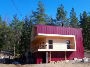 Cottage on the shore by the forest