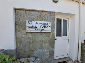 Mediterranean poolside garden cottage