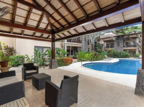 Modern Island-Themed Condo with Floor-to-Ceiling Windows & Garden and Pool Views Within Walking Distance of the Beach