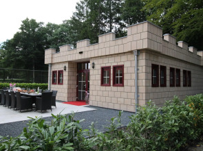 Designed home with bedstead, surrounded by forest