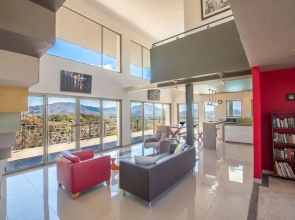 Modern Hillside Home with Sleek Interiors and Panoramic Poolside Views
